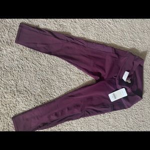 Fabletic burgundy work out pants with mesh on side and side pockets.